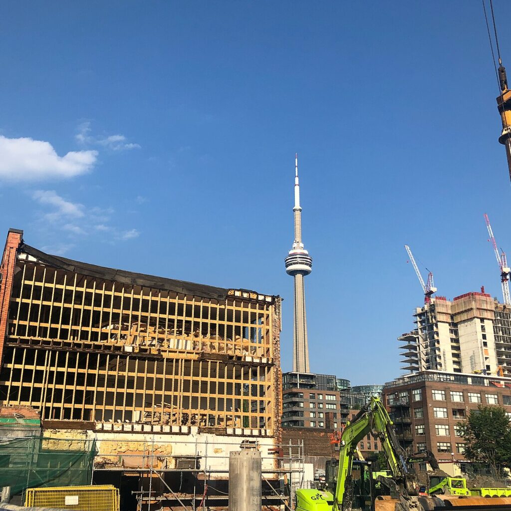 The KING Toronto development site in 2020 with retained heritage facades and the CN Tower