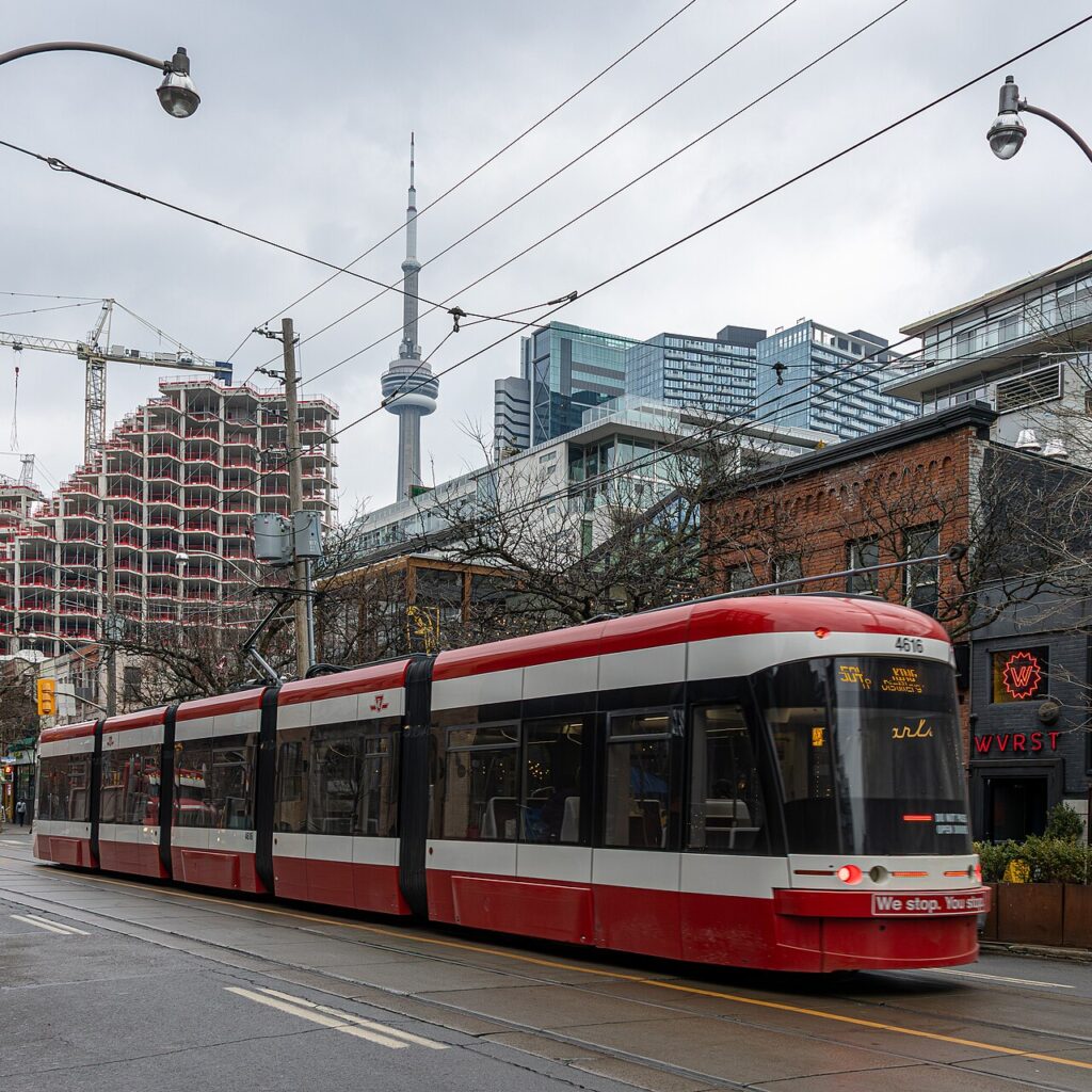 TTC streetcar on King Street West passing the KING Toronto construction site, December 2025